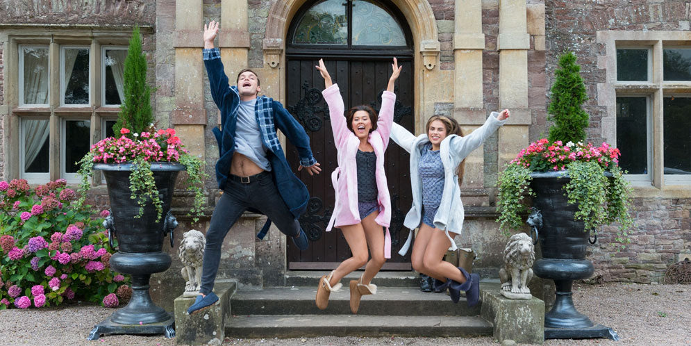 People jumping in dressing gowns and slippers