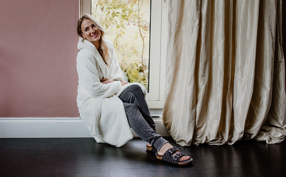 Girl sitting wearing a cream dressing gown