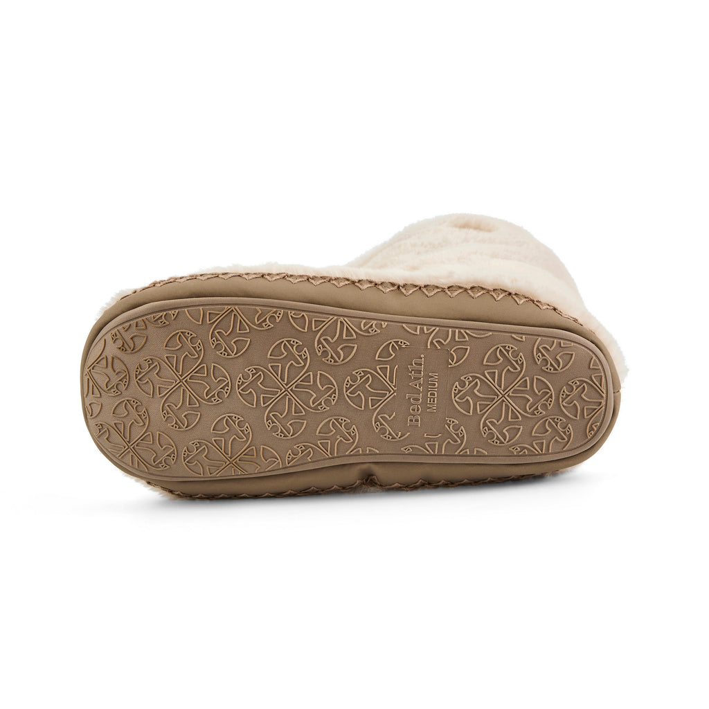 Close-up of a beige slipper with brand logo on the sole against a white background