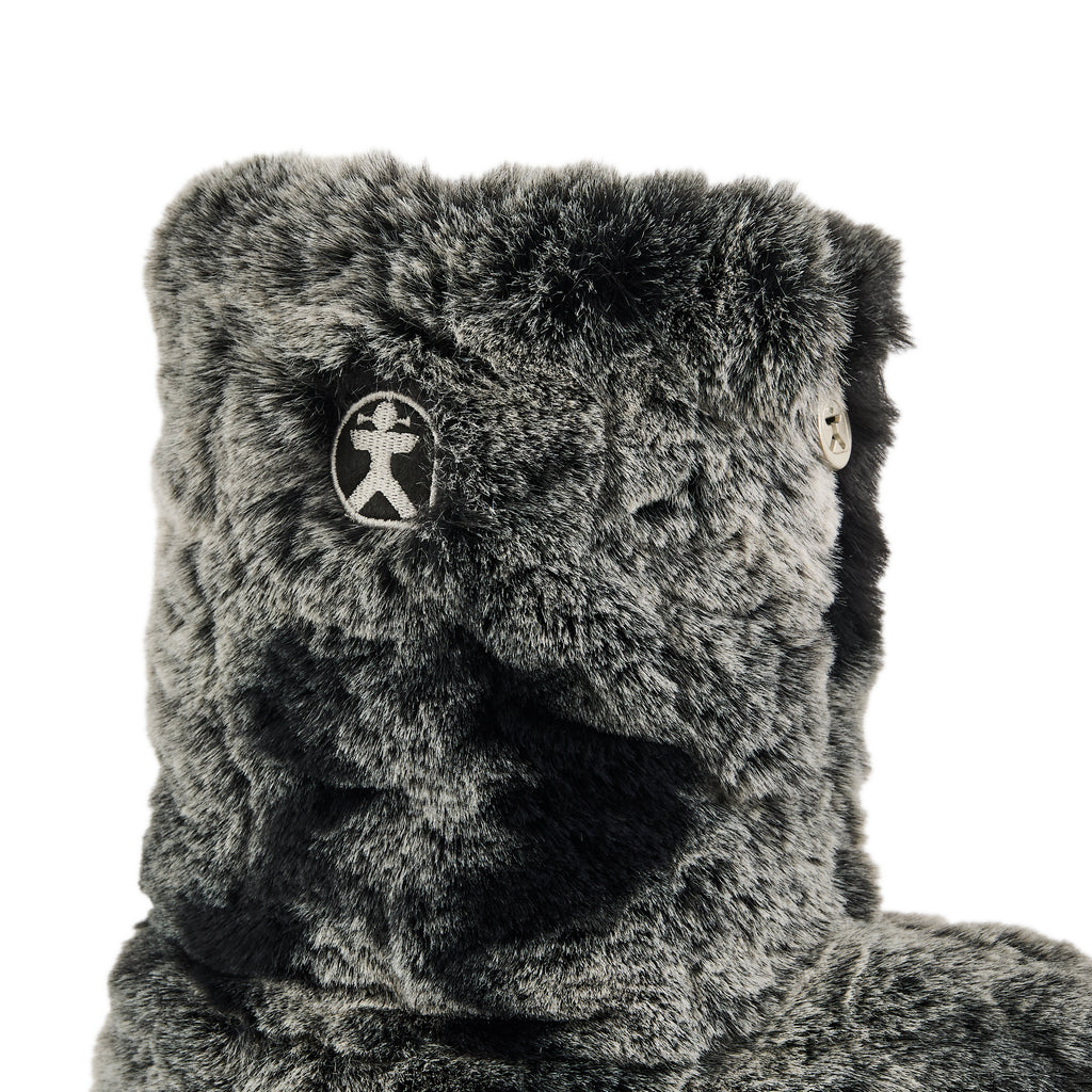 Grey plush toy with a logo on a white background