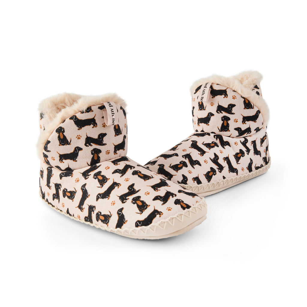 Pair of slippers with dog pattern on a white background