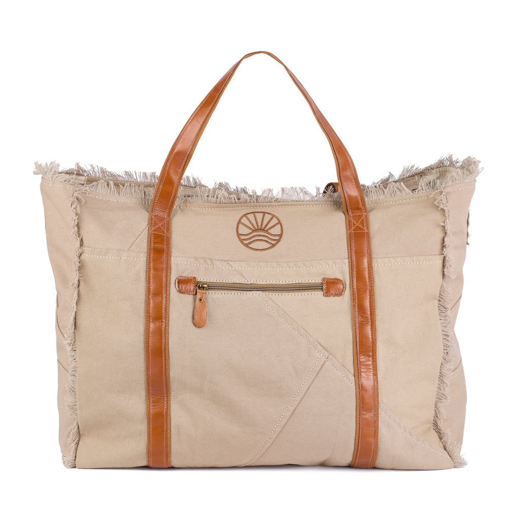 Bonnie: a beige washed canvas beach bag with frayed raw edges, tan leather handles and trim, and an embroidered Beach Athletics logo, back view