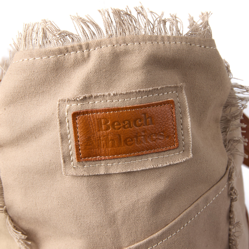 Bonnie bag (a beige washed canvas beach bag), close-up of the branded leather logo patch
