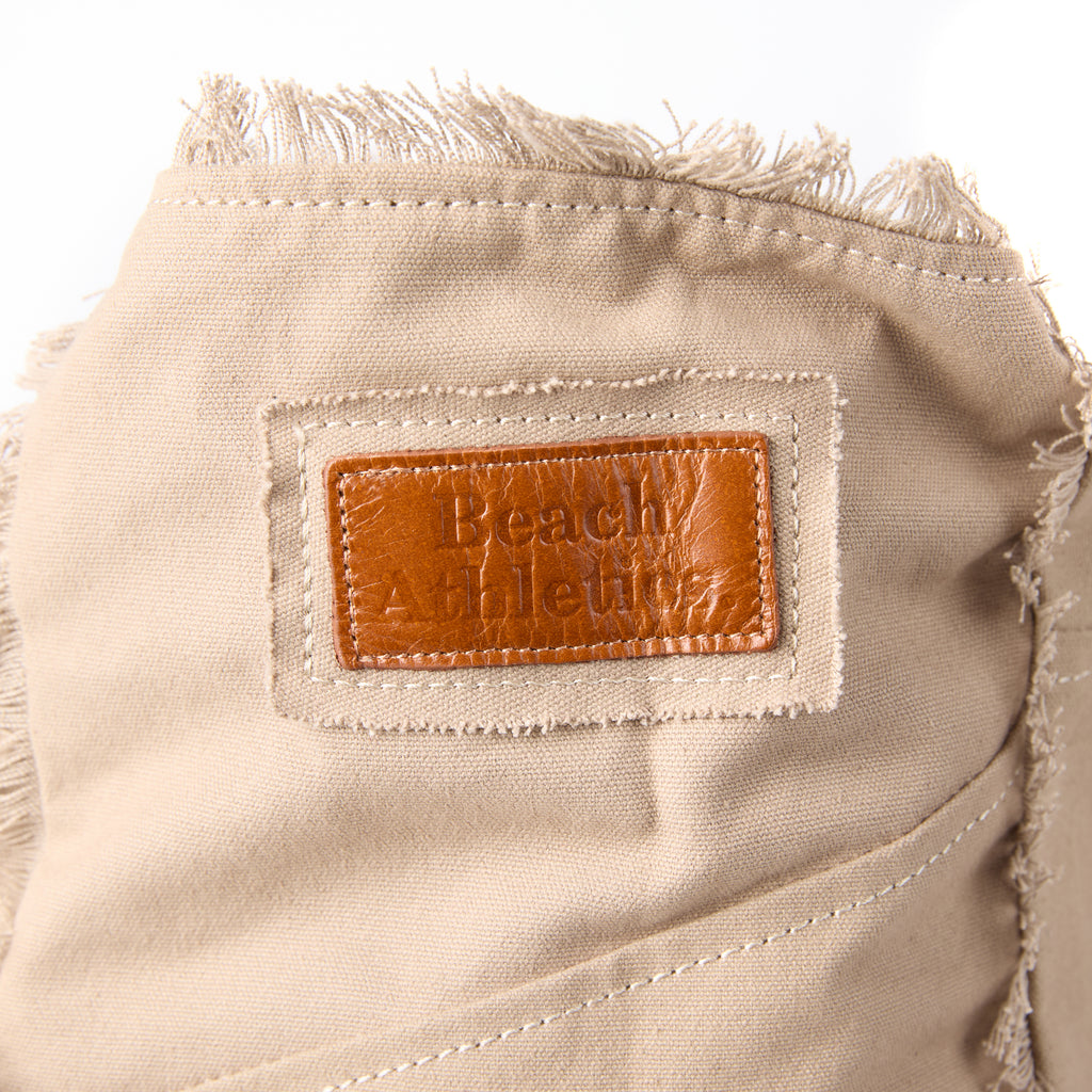 Casey bag (a beige washed canvas beach bag), close-up of the embroidered Beach Athletics logo patch