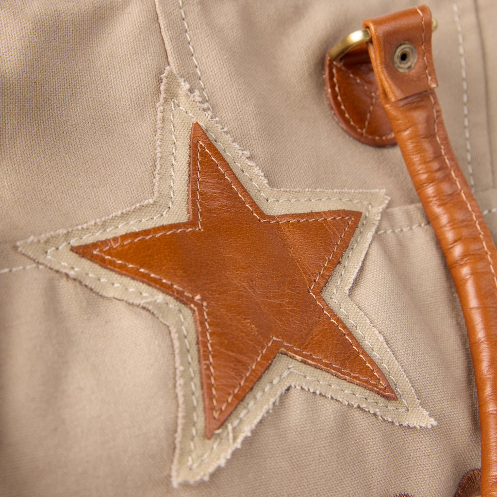 Casey bag (a beige washed canvas beach bag), close-up of the star patch on the front