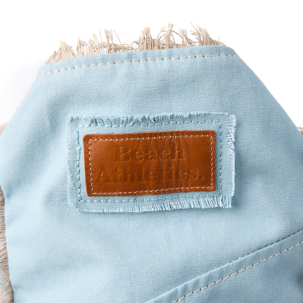 Casey bag (a blue washed canvas beach bag), close-up of the embroidered Beach Athletics logo patch