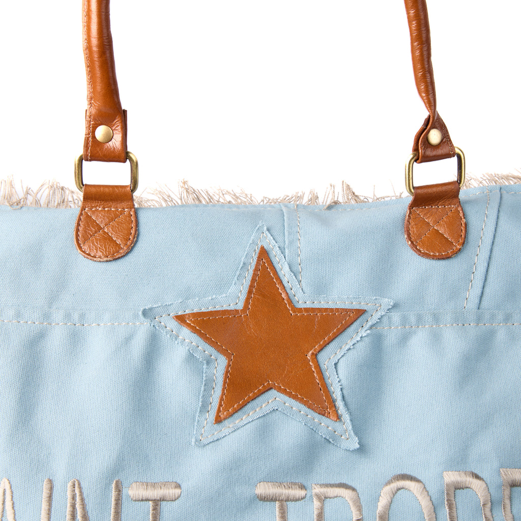 Casey bag (a blue washed canvas beach bag), close-up of the star patch on the front