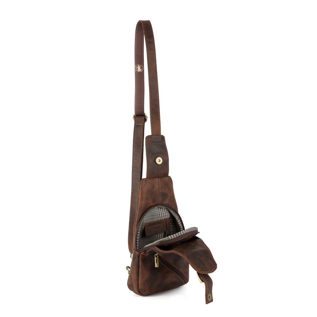 Chiesa: a brown distressed leather chest/sling bag with a long adjustable crossbody strap, a front flap pocket and a houndstooth-check lining, shown at an angle