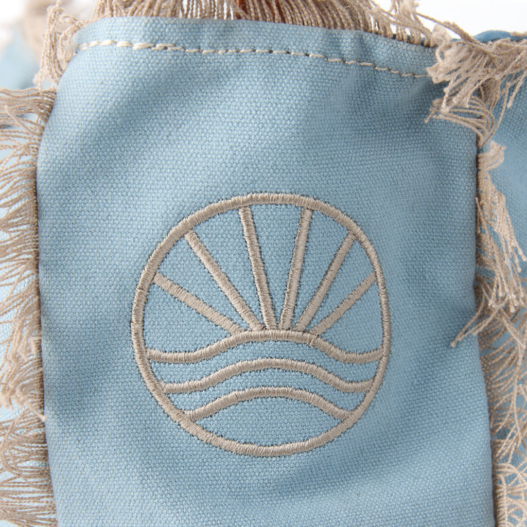 Lani bag (a blue washed canvas shoulder bag), close-up of the embroidered Beach Athletics logo