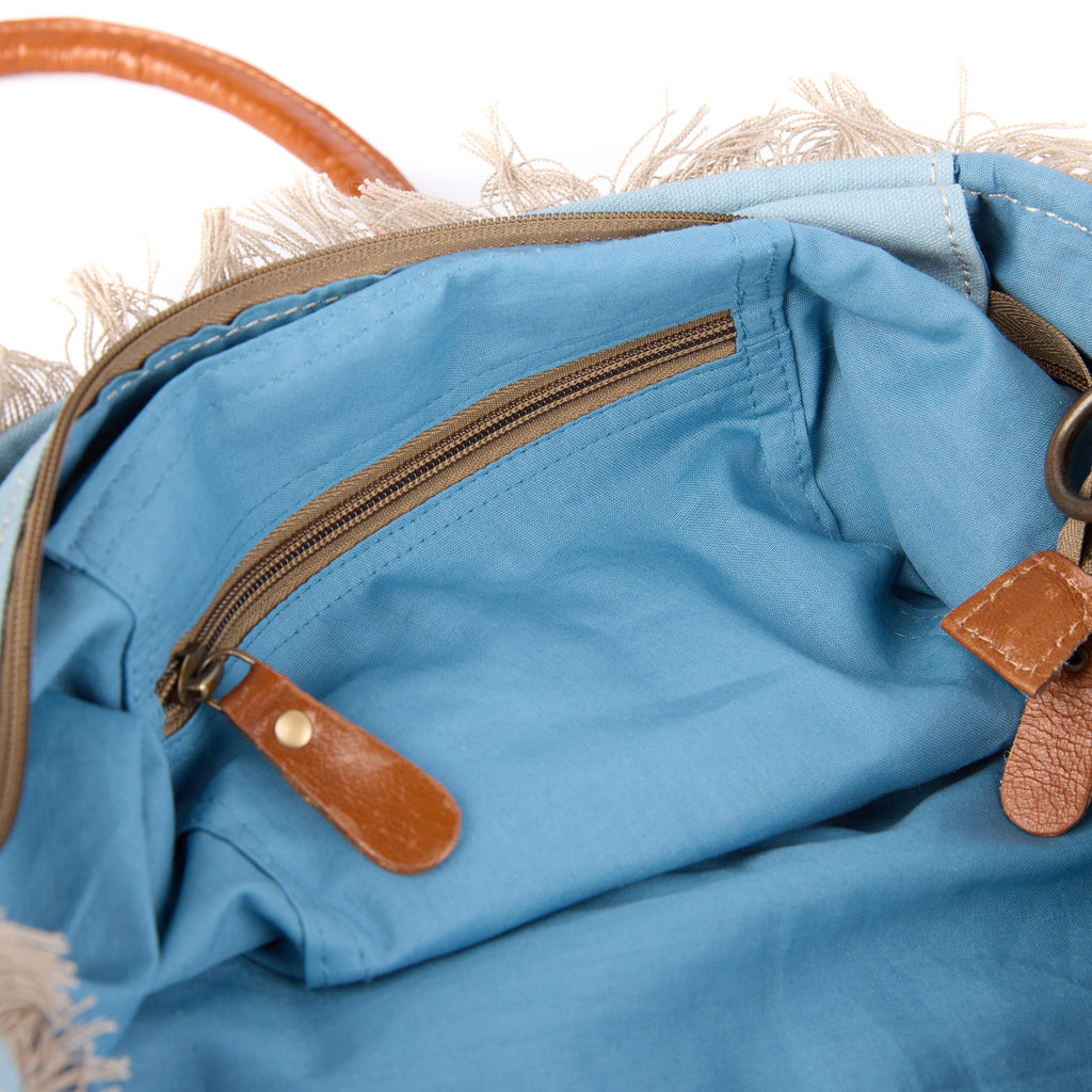 Lani bag (a blue washed canvas shoulder bag), interior view showing an inside pocket