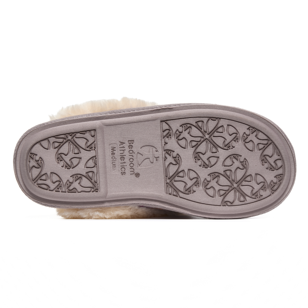 Close-up of a shoe sole with a Harris Tweed brand logo on a white background