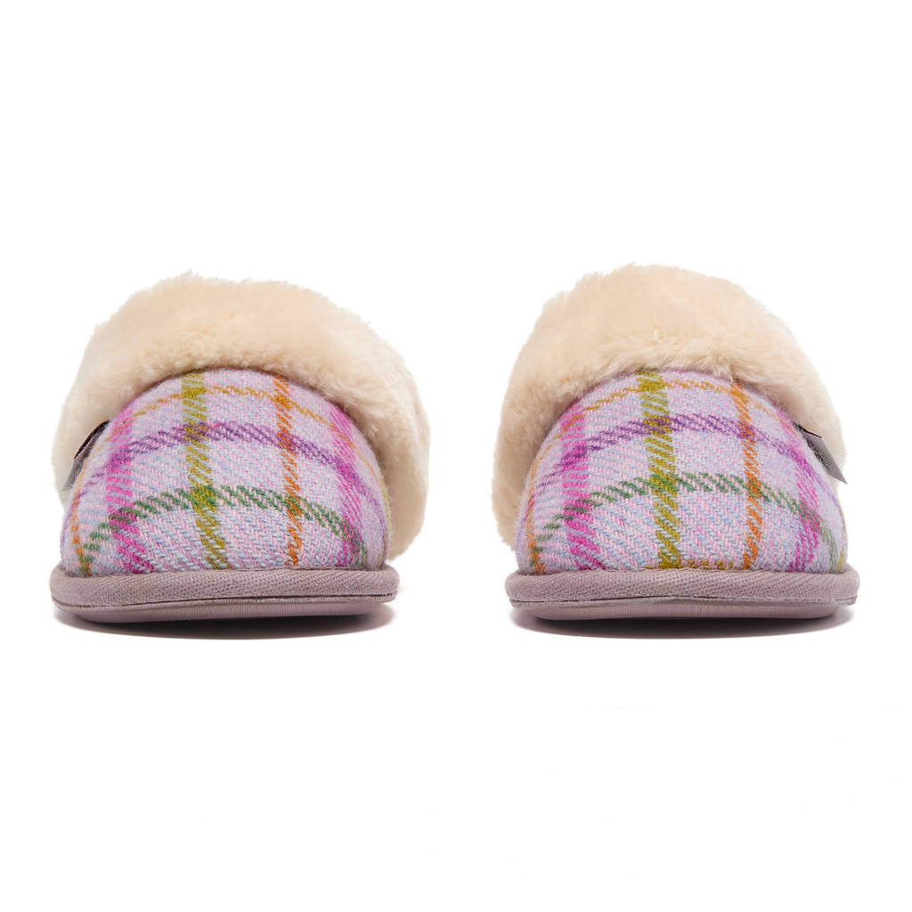 Pair of Harris Tweed plaid slippers with fur trim on a white background