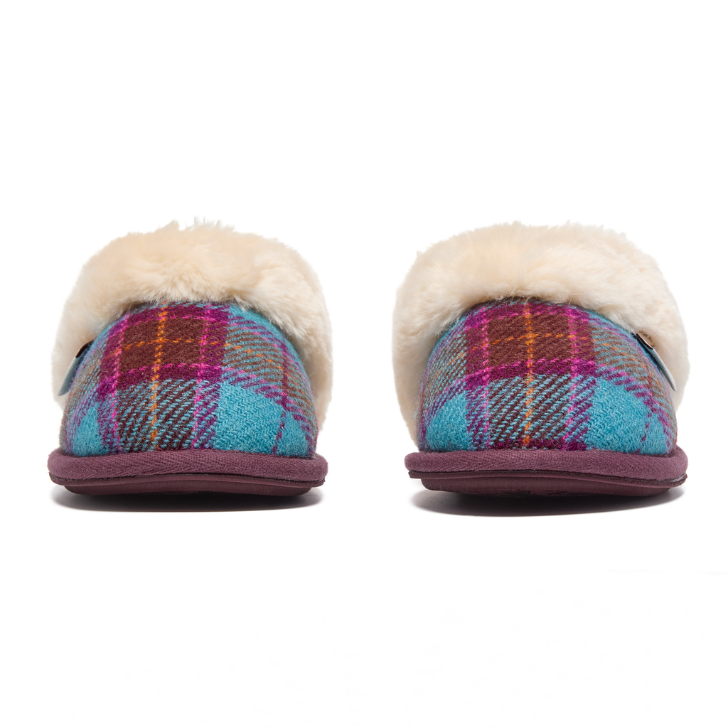 Pair of Harris Tweed plaid slippers with white fur lining on a white background