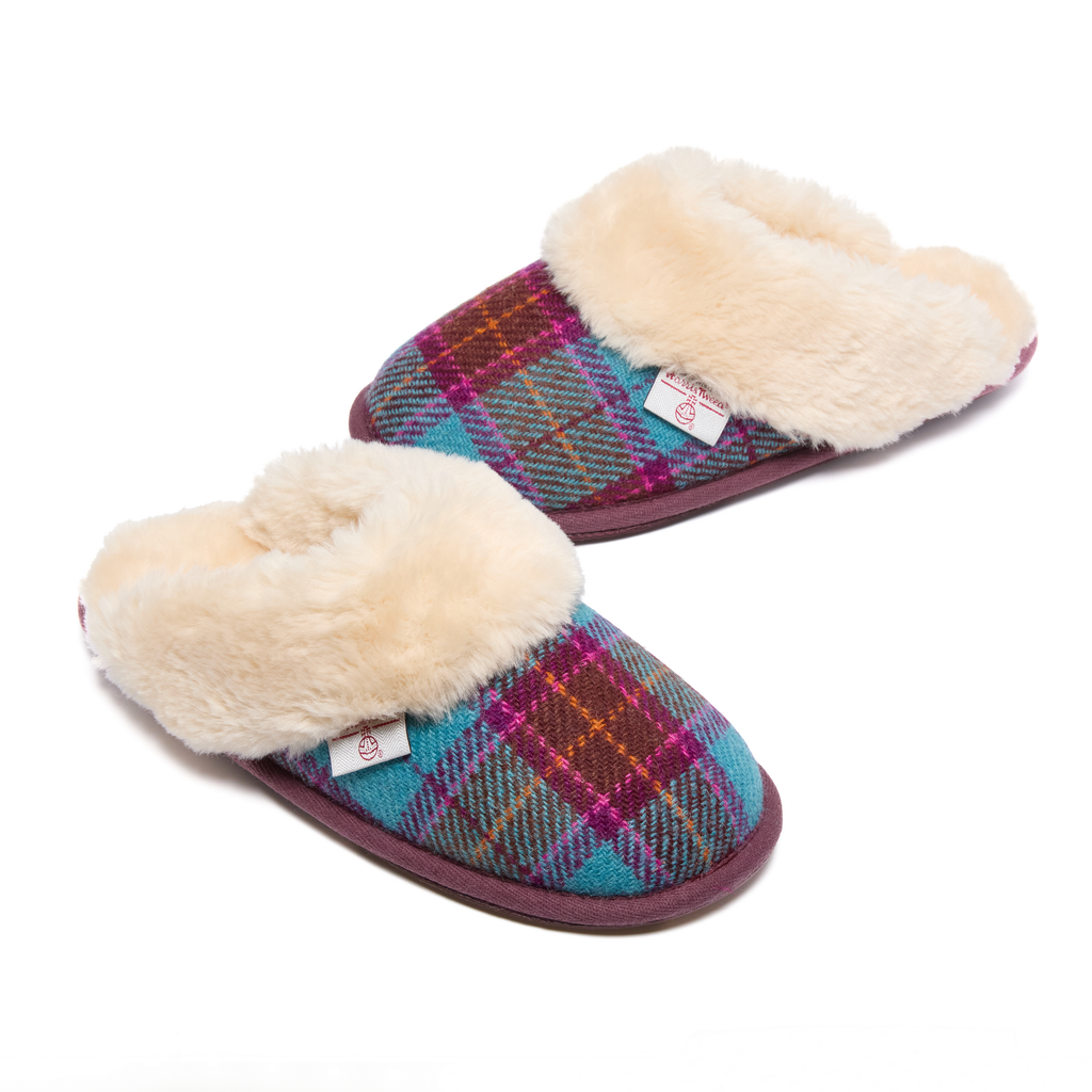 Pair of Harris Tweed plaid slippers with fluffy fur lining on a white background
