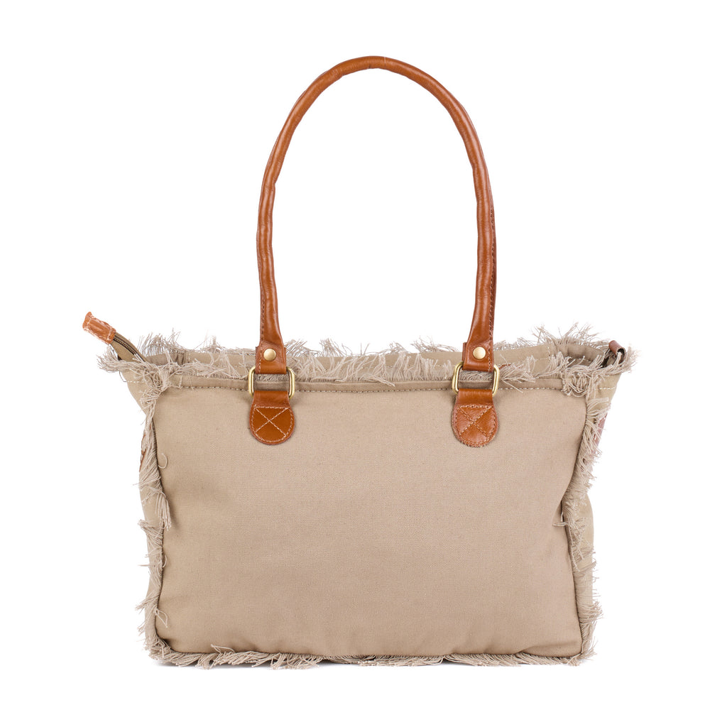 Shauni: a beige washed canvas shoulder bag with frayed raw edges, tan leather trim and an embroidered sunrise Beach Athletics logo, back view