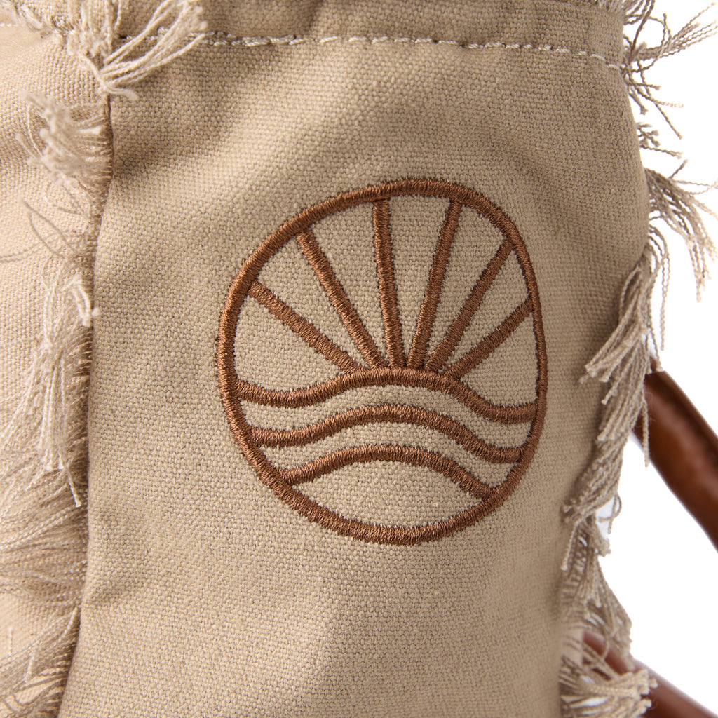 Shauni bag (a beige washed canvas shoulder bag), close-up of the embroidered Beach Athletics logo