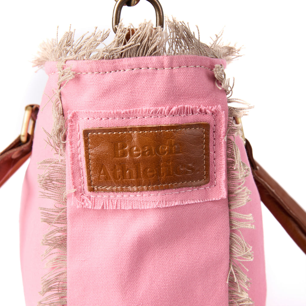 Shauni bag (a pink washed canvas shoulder bag), close-up of the embroidered Beach Athletics logo patch