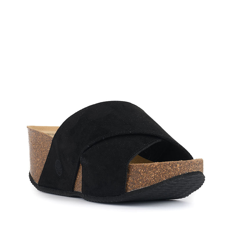The Inis Vegan Wedge Crossover Slider in Black has elegant style and comfort combined. Bedroom Athletics offers a wide range of premium quality slippers, slip on boots and loungewear.